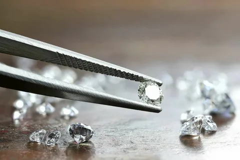 An ethically sourced, brilliant-cut gemstone held by tweezers, signifying transparency and quality.